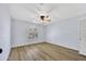 Empty bedroom featuring neutral walls, wood floor, and a window with plantation shutters at 5728 E Sharon Dr, Scottsdale, AZ 85254