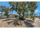 Charming single-story home featuring mature trees and desert landscaping in the front yard at 5728 E Sharon Dr, Scottsdale, AZ 85254