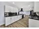 Bright kitchen with white cabinets, black countertops, backsplash, and stainless steel appliances at 5728 E Sharon Dr, Scottsdale, AZ 85254