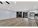Open concept living room with wood floors, fireplace, modern kitchen with stainless steel appliances at 5728 E Sharon Dr, Scottsdale, AZ 85254