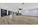 Spacious open-concept living room with wood flooring, fireplace, and modern kitchen at 5728 E Sharon Dr, Scottsdale, AZ 85254