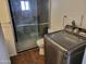 Bathroom with modern walk-in shower, toilet, and stainless steel washing machine at 61 W Southern Ave # 31, Mesa, AZ 85210