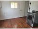 Laundry area with wood-look flooring, standard window, and stainless steel dryer at 61 W Southern Ave # 31, Mesa, AZ 85210