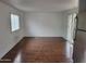 Spacious living room with wood-look floors, ample light, and a sliding glass door at 61 W Southern Ave # 31, Mesa, AZ 85210