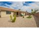 Expansive backyard featuring a covered patio and low-maintenance desert landscaping at 6160 S Pebble Beach Dr, Chandler, AZ 85249