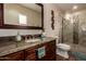 Bathroom with granite countertop, framed mirror and tiled walk-in shower at 6160 S Pebble Beach Dr, Chandler, AZ 85249