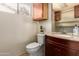 Bathroom features a wood cabinet, granite countertop and framed mirror at 6160 S Pebble Beach Dr, Chandler, AZ 85249