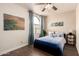 Bedroom with natural light, ceiling fan and wood laminate flooring at 6160 S Pebble Beach Dr, Chandler, AZ 85249