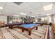 Billiard room featuring multiple pool tables, comfortable seating, and ample lighting at 6160 S Pebble Beach Dr, Chandler, AZ 85249