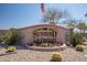 Landscaped sign of SunBird Golf Resort community featuring colorful flowers and desert foliage at 6160 S Pebble Beach Dr, Chandler, AZ 85249
