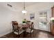 Cozy dining area with a round table, four chairs, and access to the outdoor patio at 6160 S Pebble Beach Dr, Chandler, AZ 85249