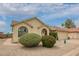 Landscaped single-story home exterior with arched windows, a two-car garage, and drought-resistant desert landscaping at 6160 S Pebble Beach Dr, Chandler, AZ 85249