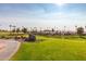 Scenic view of the SunBird Golf Course, featuring well-manicured green and a tranquil lake at 6160 S Pebble Beach Dr, Chandler, AZ 85249