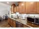 Modern kitchen featuring granite countertops, stainless steel appliances, and wood cabinetry at 6160 S Pebble Beach Dr, Chandler, AZ 85249