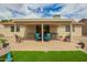 Inviting covered patio featuring comfortable seating and a well-manicured artificial lawn at 6160 S Pebble Beach Dr, Chandler, AZ 85249