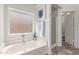 This bright bathroom features a soaking tub under a frosted window, with a standup shower visible at 725 S Canfield --, Mesa, AZ 85208