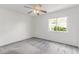Bedroom features ceiling fan, neutral carpet, and window providing natural light and outdoor views at 725 S Canfield --, Mesa, AZ 85208