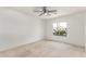 Bright bedroom featuring ceiling fan, neutral carpet, and window views of greenery at 725 S Canfield --, Mesa, AZ 85208