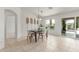 Bright dining room featuring a black table, four chairs, and sliding glass doors to the backyard at 725 S Canfield --, Mesa, AZ 85208