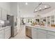 Open kitchen with stainless steel appliances overlooking dining area and backyard with a pool at 725 S Canfield --, Mesa, AZ 85208