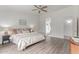 Serene primary bedroom with ceiling fan, wood-look floors, and ensuite bathroom access at 725 S Canfield --, Mesa, AZ 85208