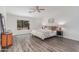 Cozy primary bedroom with hardwood floors, ceiling fan, and an exterior view from a window at 725 S Canfield --, Mesa, AZ 85208