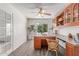 Office features a wooden desk, ceiling fan, and built-in shelves, perfect for remote work at 725 S Canfield --, Mesa, AZ 85208