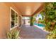 Covered patio area perfect for relaxing while enjoying outdoor living with pavers and vibrant greenery at 725 S Canfield --, Mesa, AZ 85208