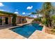 Backyard pool showcasing travertine tile, an outdoor oasis, a waterfall feature and lush landscaping at 725 S Canfield --, Mesa, AZ 85208