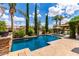 Sparkling pool, surrounded by lush landscaping, mature trees, and poolside lounge chairs, creates a backyard oasis at 725 S Canfield --, Mesa, AZ 85208