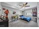 Comfortable bedroom with desk, fan, and carpeted flooring at 8034 E Del Caverna Dr, Scottsdale, AZ 85258