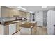 Well-lit kitchen featuring modern appliances and an island with a cooktop at 8034 E Del Caverna Dr, Scottsdale, AZ 85258