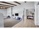 Bright living room with a vaulted ceiling, beams, and a combination of carpet and tile flooring at 8034 E Del Caverna Dr, Scottsdale, AZ 85258