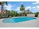 Stunning pool area featuring a sparkling pool, mature trees, and comfortable lounge chairs for outdoor relaxation at 8034 E Del Caverna Dr, Scottsdale, AZ 85258