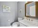Charming powder room with gray walls, white fixtures, and decorative mirror over the sink at 8034 E Del Caverna Dr, Scottsdale, AZ 85258