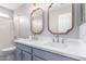 This bathroom features a double sink vanity with decorative mirrors and framed pulls at 8500 W Saint John Rd, Peoria, AZ 85382