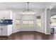 Bright eat-in kitchen with white cabinets, granite counters, and a large window at 8500 W Saint John Rd, Peoria, AZ 85382