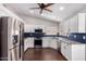 Modern kitchen with stainless steel appliances, white cabinets, and dark countertops at 8500 W Saint John Rd, Peoria, AZ 85382