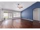 Bright living room featuring wood floors, a ceiling fan, and sliding glass doors at 8500 W Saint John Rd, Peoria, AZ 85382