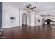 Open-concept living room with hardwood floors, brick accent wall and modern lighting at 8500 W Saint John Rd, Peoria, AZ 85382