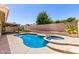 Relaxing backyard featuring a sparkling pool, spa, and desert landscaping at 8500 W Saint John Rd, Peoria, AZ 85382