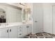 Bright bathroom with dual sinks, white cabinetry, and decorative tile flooring at 9575 S Ash Ave, Tempe, AZ 85284