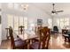 Elegant dining room with vaulted ceilings, hardwood floors, plantation shutters, and a stylish chandelier at 9575 S Ash Ave, Tempe, AZ 85284