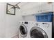 Well-lit laundry room features a full-sized washer and dryer at 9575 S Ash Ave, Tempe, AZ 85284