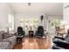 Bright living room features hardwood floors, white walls and plantation shutters for abundant natural light at 9575 S Ash Ave, Tempe, AZ 85284