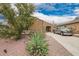 Inviting single-story home featuring desert landscaping and a long driveway at 980 W Prior Ave, Coolidge, AZ 85128