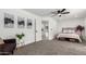 Neutral bedroom showcasing ceiling fan, ensuite access, and accent wall art at 9855 S 47Th Pl, Phoenix, AZ 85044