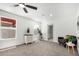 Bright bedroom features neutral decor, ceiling fan, and ensuite bath access at 9855 S 47Th Pl, Phoenix, AZ 85044