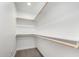 Empty walk-in closet showcasing wood closet rods and neutral carpet at 9855 S 47Th Pl, Phoenix, AZ 85044