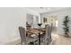 Cozy dining room featuring a wooden table, elegant chairs, and a stylish rug at 9855 S 47Th Pl, Phoenix, AZ 85044